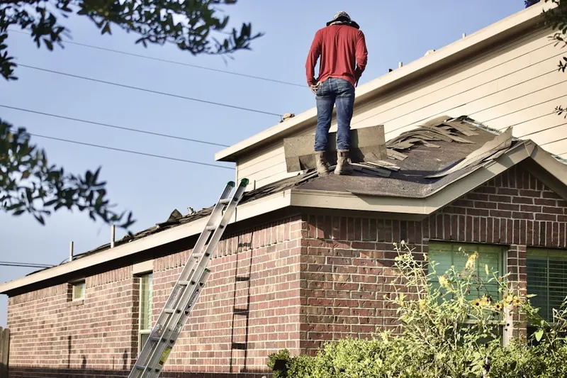 Professional roofer working on a residential roof in Cedar Pointe Condominiums